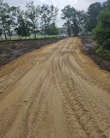 Long, graded dirt access road on a rural property